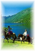 horseback riding by a forest lake in Chile